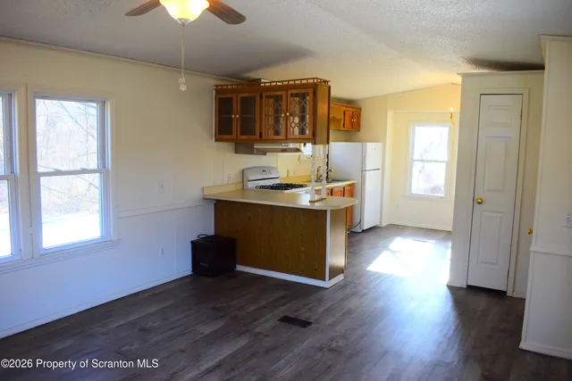 a view of a kitchen cabinets and wooden floor windows