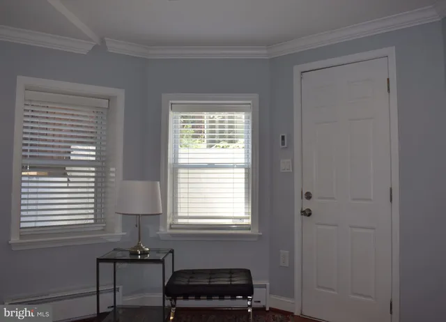a bedroom with a window and a chair