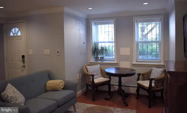 a dining room with furniture and a window