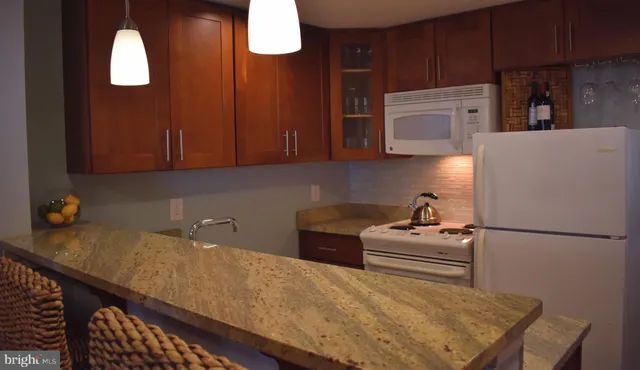 a kitchen with stainless steel appliances wooden cabinets and a refrigerator