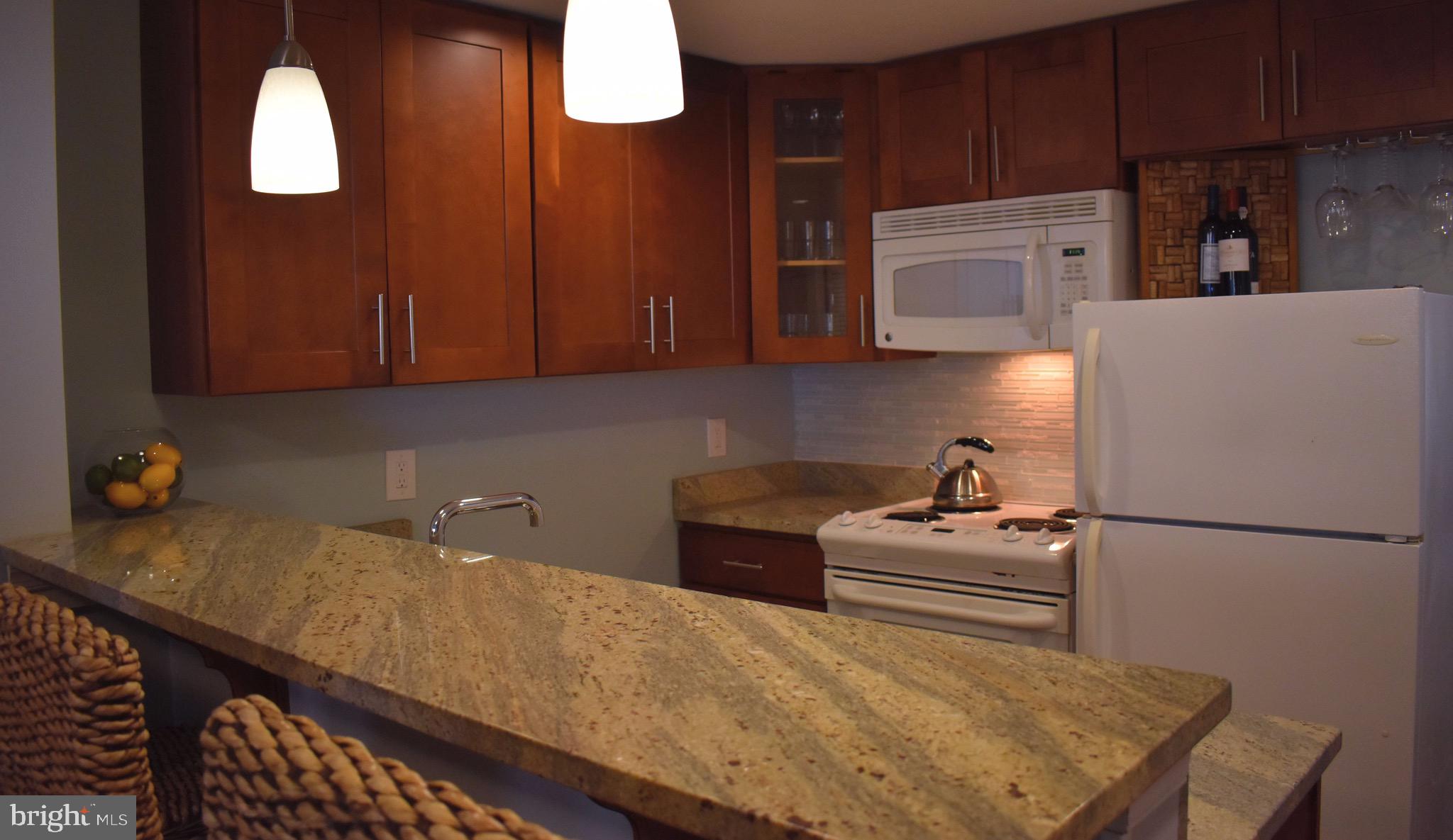 22 N Street Northwest, Unit B Washington, DC 20001 - Photo 4 of 15 a kitchen with stainless steel appliances wooden cabinets and a refrigerator