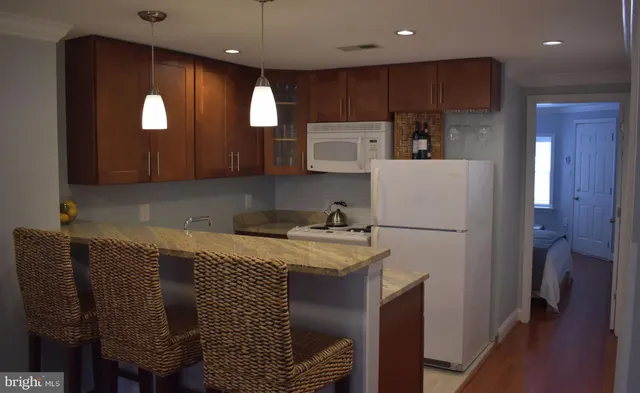 a kitchen with a refrigerator a sink and cabinets