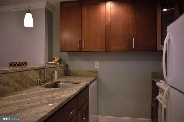 a kitchen with a sink cabinets and appliances