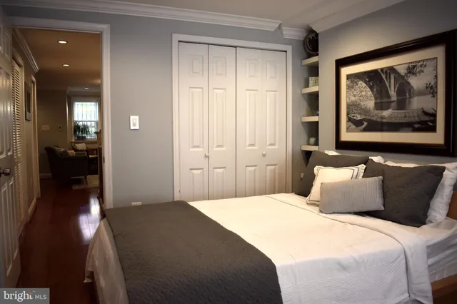 a bedroom with a bed and a painting on the wall