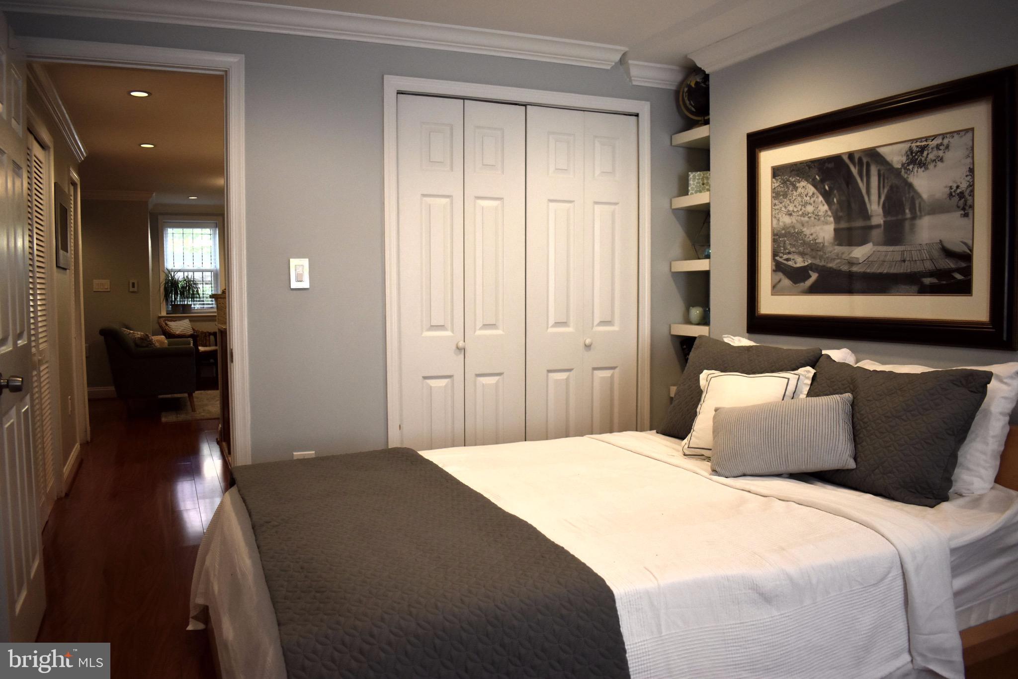 22 N Street Northwest, Unit B Washington, DC 20001 - Photo 9 of 15 a bedroom with a bed and a painting on the wall
