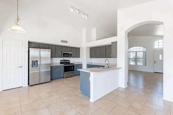 a large kitchen with cabinets and stainless steel appliances