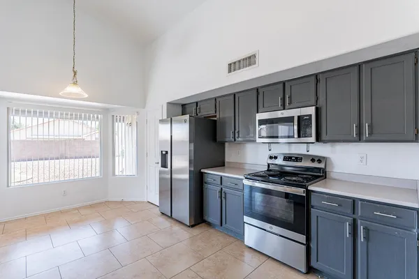 a kitchen with stainless steel appliances a stove a sink and a microwave