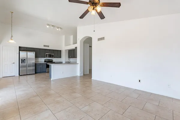 a view of an empty room with a fireplace and a window