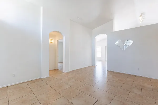 an empty room with windows and closet
