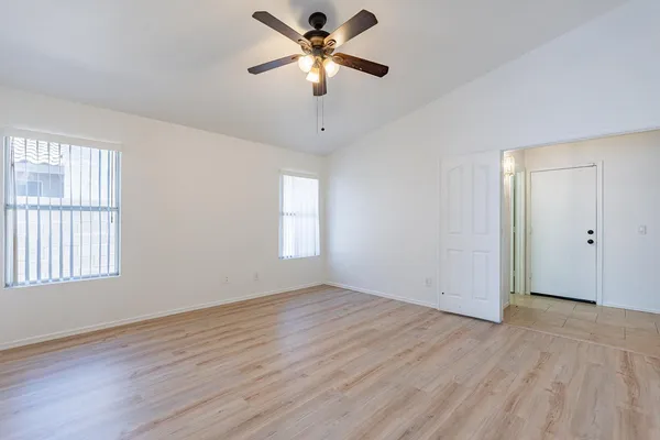 a view of an empty room with wooden floor