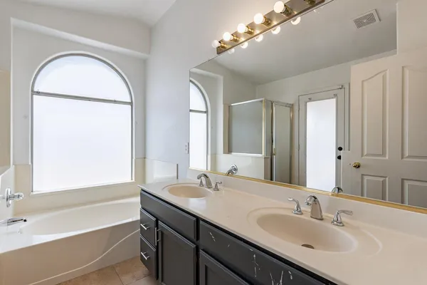 a bathroom with a bathtub and a shower