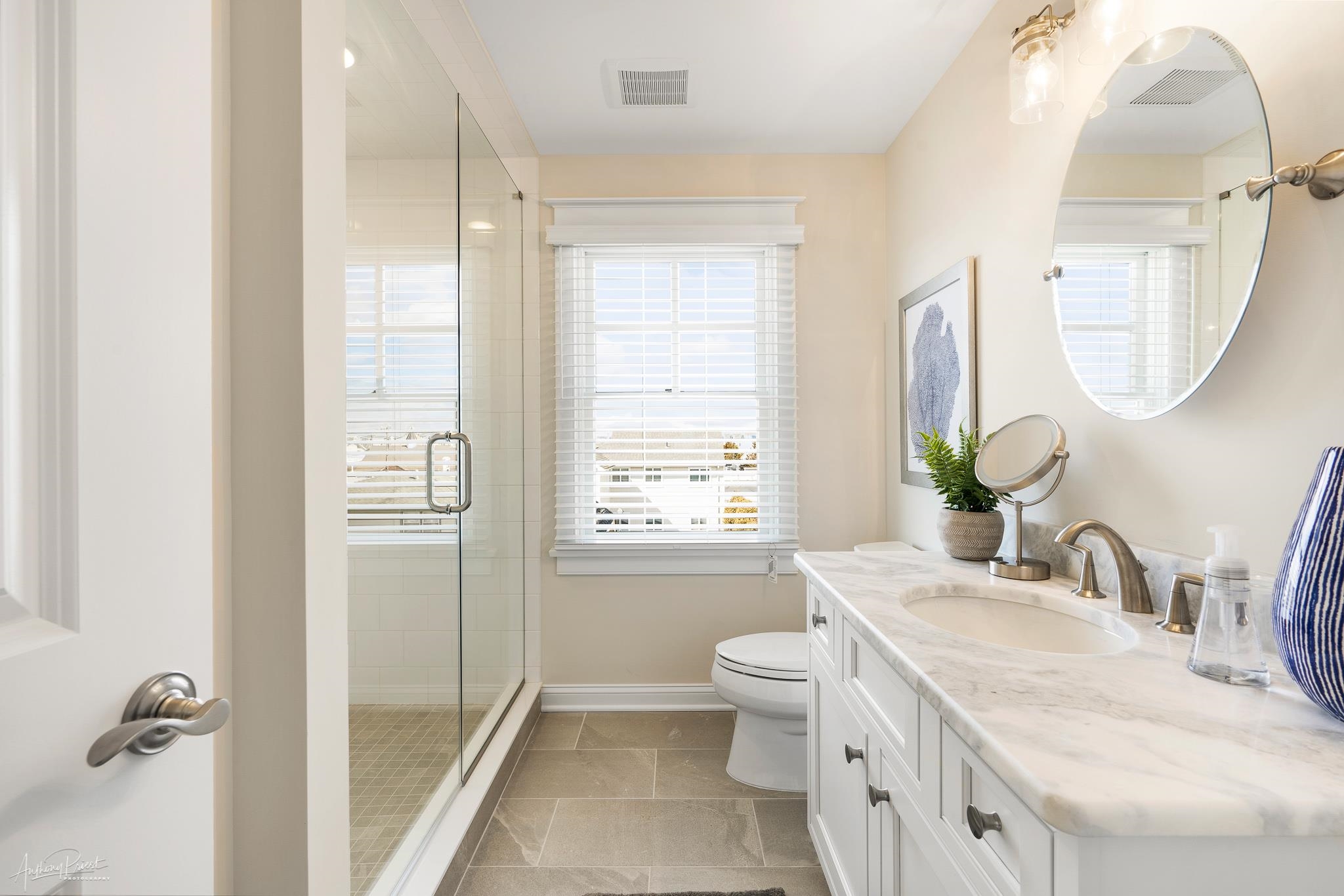 169 27th Street Avalon, NJ 08202 - Photo 24 of 32 a bathroom with a granite countertop sink a toilet and a mirror