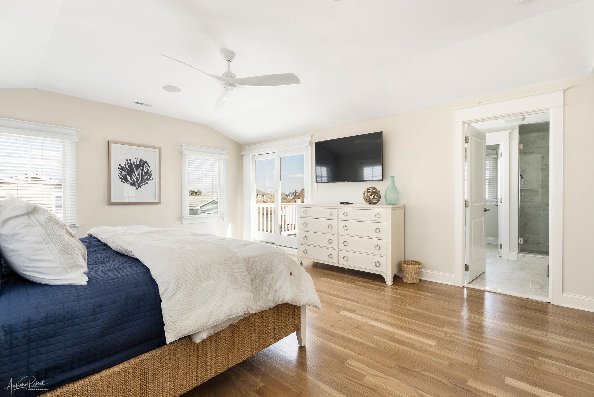 169 27th Street Avalon, NJ 08202 - Photo 25 of 32 a bedroom with a bed and a flat screen tv