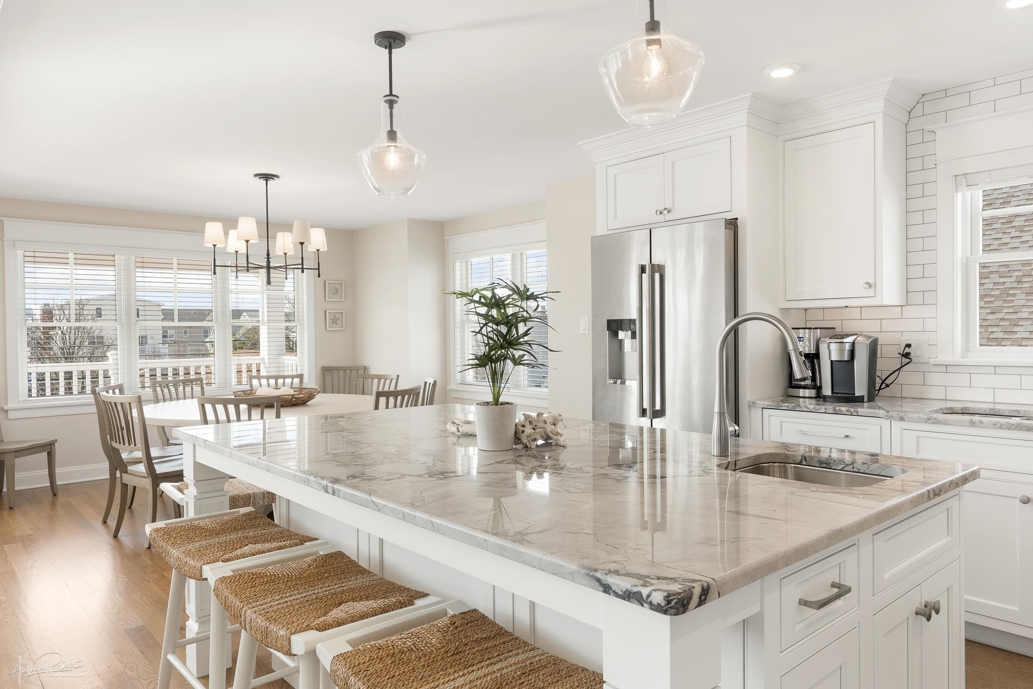 169 27th Street Avalon, NJ 08202 - Photo 4 of 32 a kitchen with stainless steel appliances granite countertop a kitchen island a stove a table and chairs