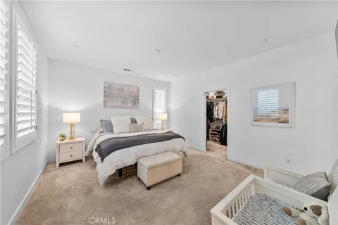 a spacious bedroom with a bed and a window