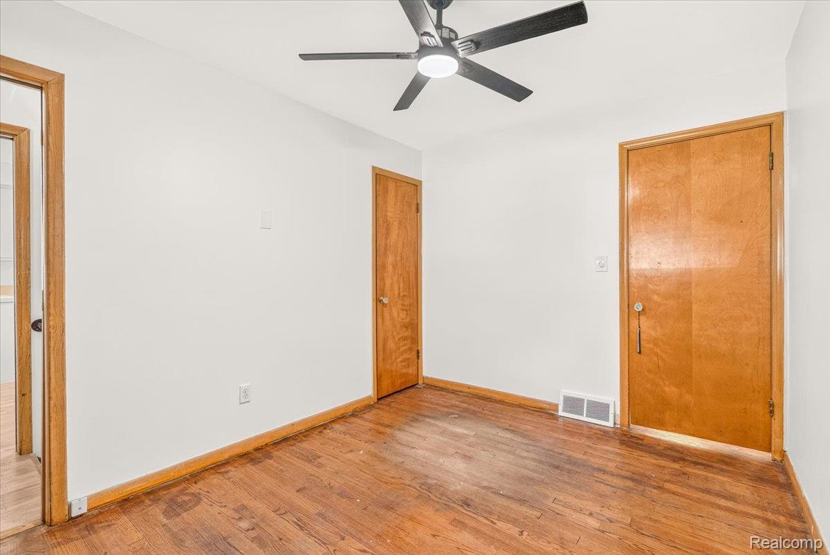 11802 Columbia Street Redford, MI 48239 - Photo 14 of 39 Bedroom 1 with Original Hardwood Floors in good condition, Vinyl Replacement Windows, and a New Ceiling Fan.