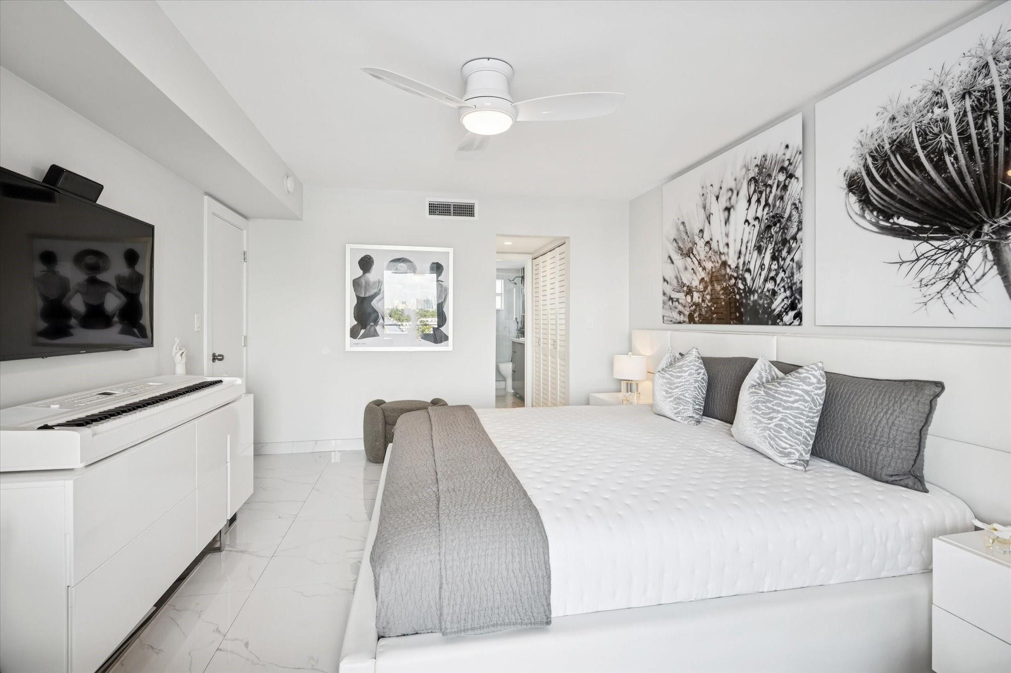 215 North Birch Road, Unit 8C Fort Lauderdale, FL 33304 - Photo 15 of 22 a bedroom with a bed and a flat screen tv