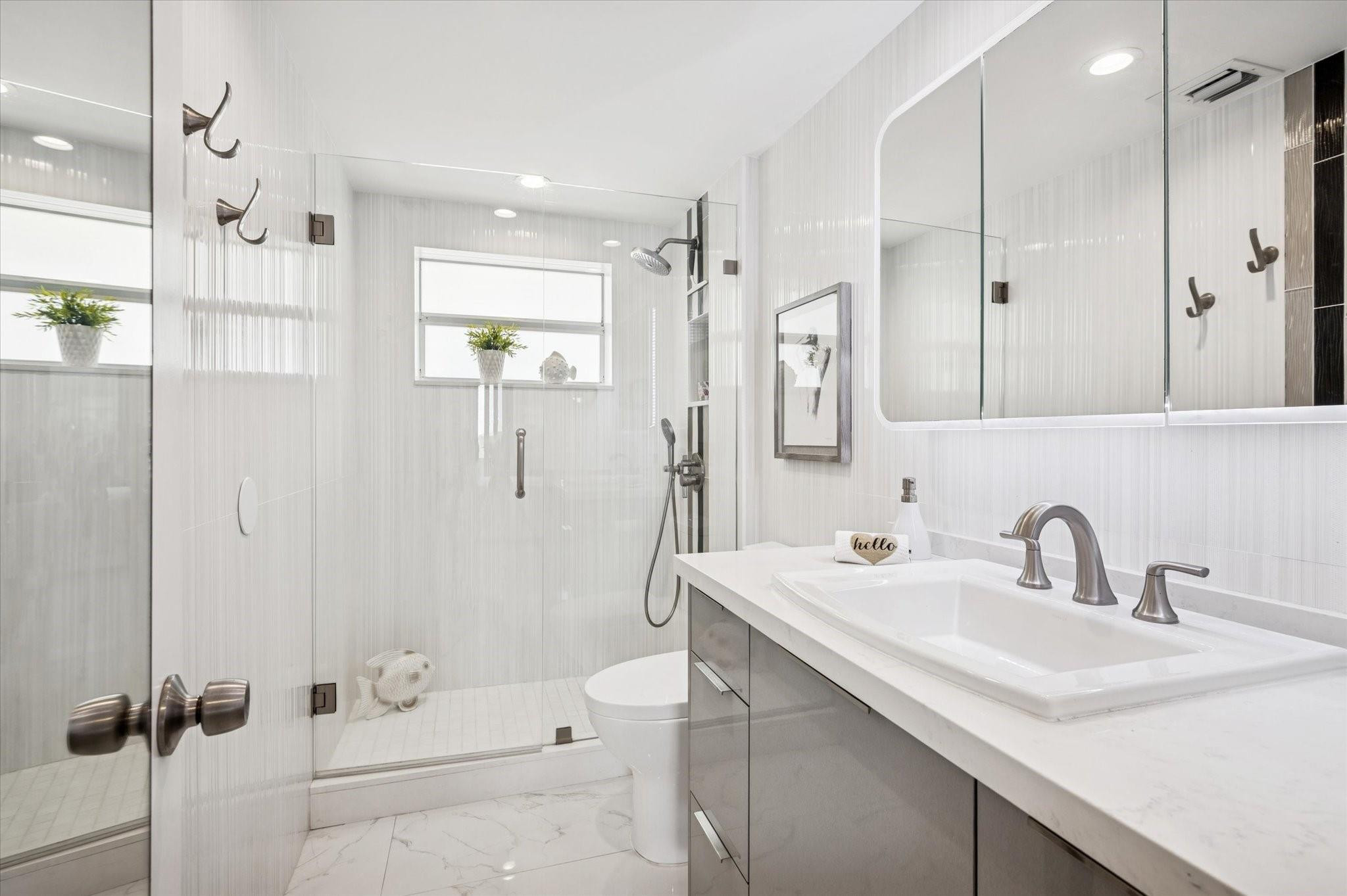 215 North Birch Road, Unit 8C Fort Lauderdale, FL 33304 - Photo 16 of 22 a bathroom with a sink a toilet and shower