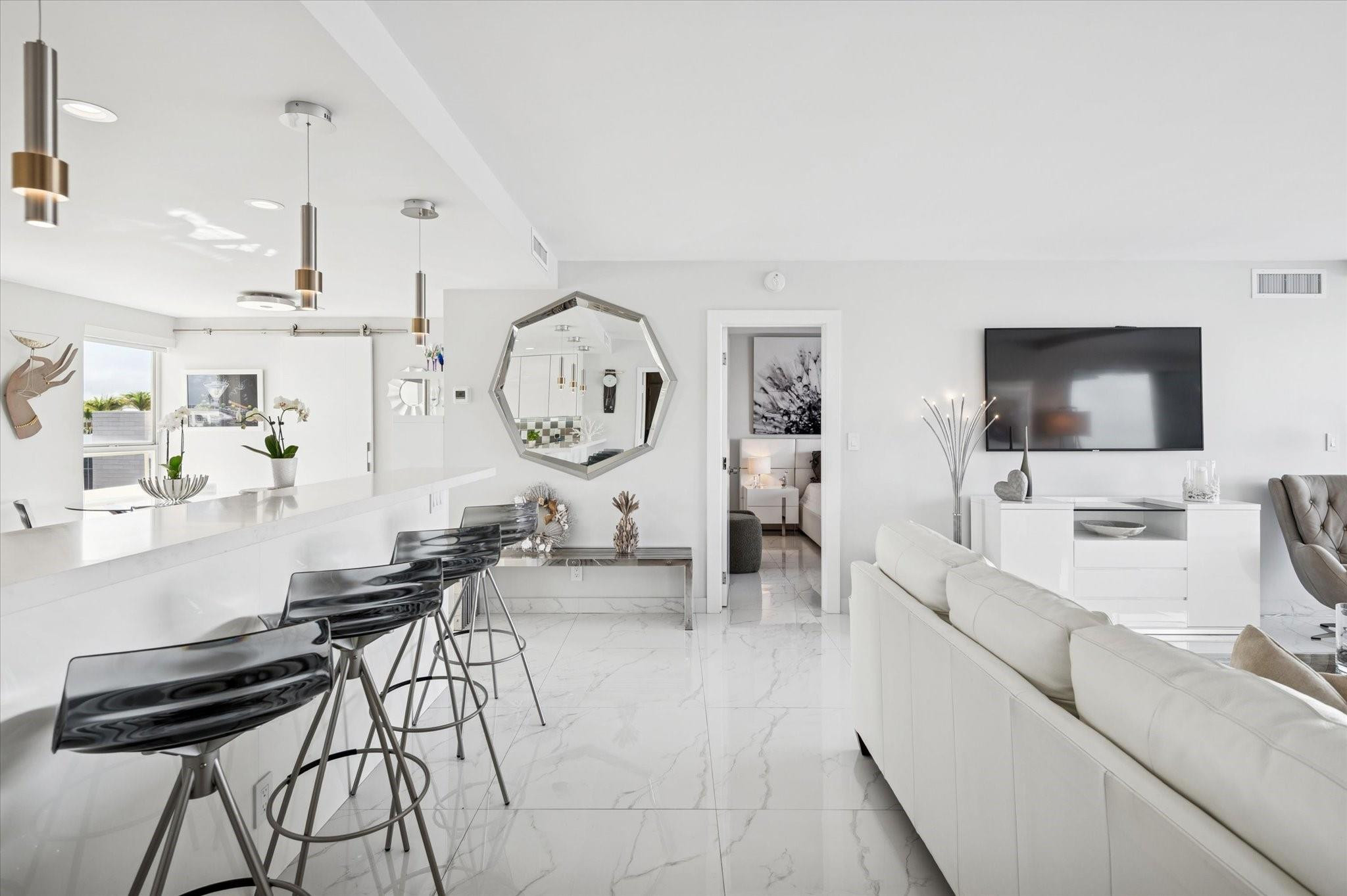 215 North Birch Road, Unit 8C Fort Lauderdale, FL 33304 - Photo 2 of 22 a living room with furniture and a flat screen tv
