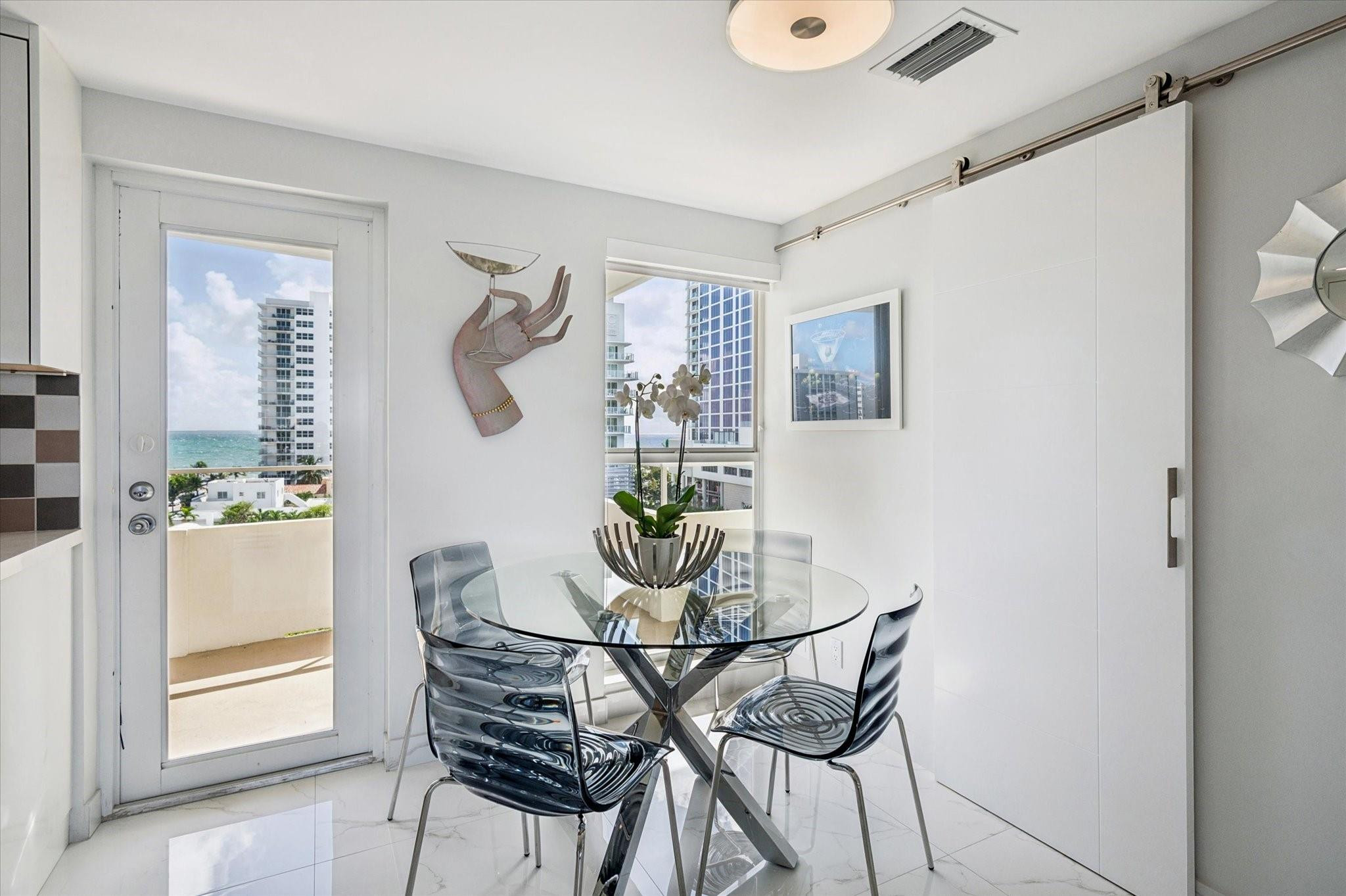 215 North Birch Road, Unit 8C Fort Lauderdale, FL 33304 - Photo 4 of 22 a dining room with furniture and window