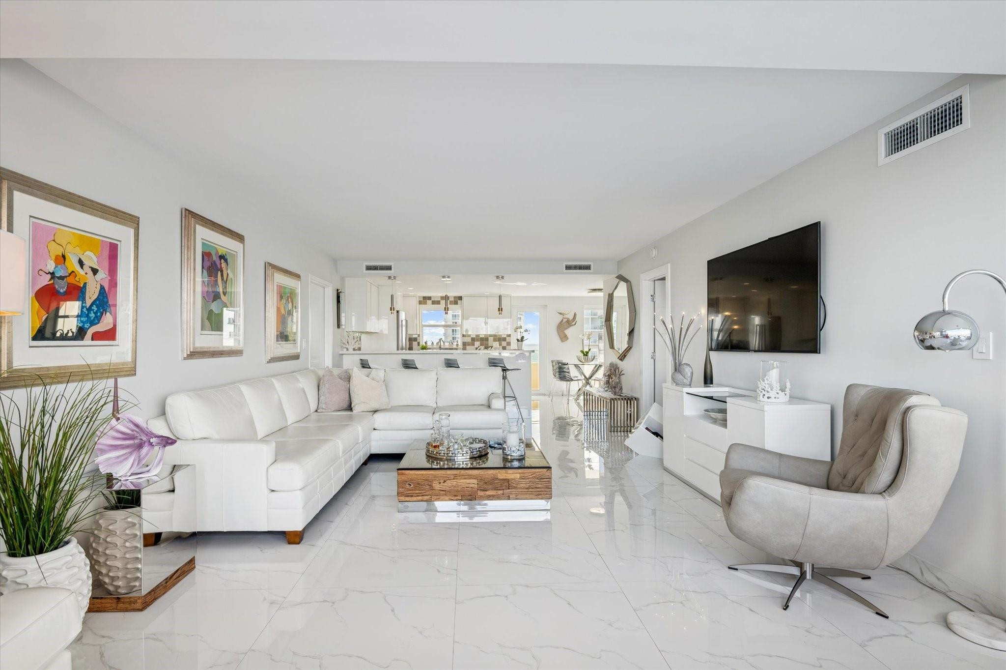 215 North Birch Road, Unit 8C Fort Lauderdale, FL 33304 - Photo 8 of 22 a living room with furniture and a flat screen tv