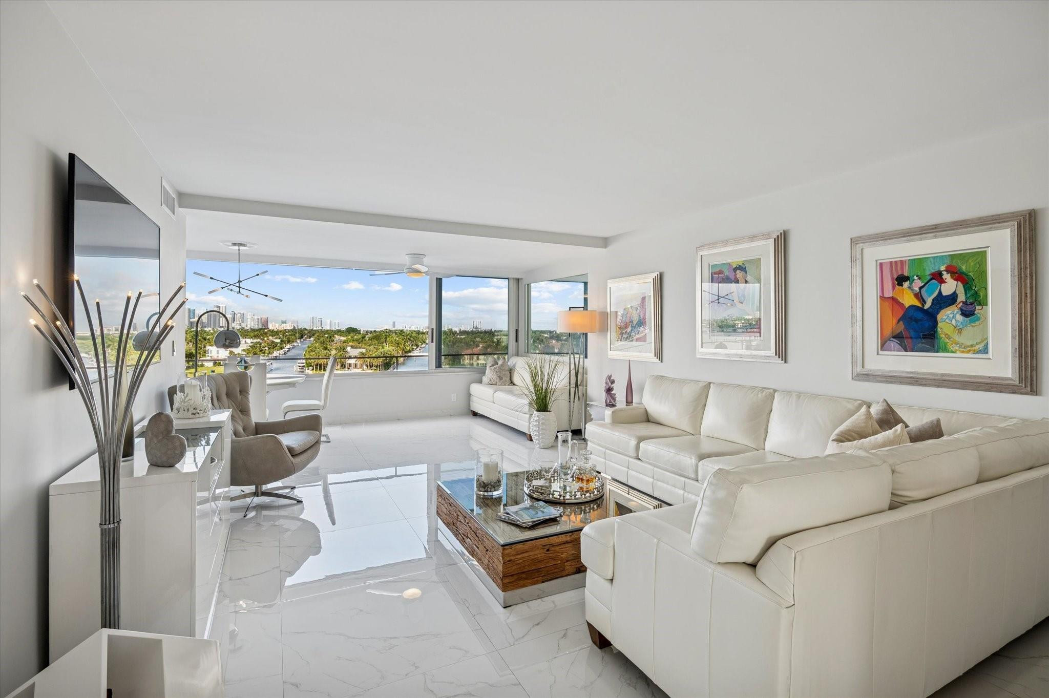 215 North Birch Road, Unit 8C Fort Lauderdale, FL 33304 - Photo 9 of 22 a living room with furniture yard and a large window