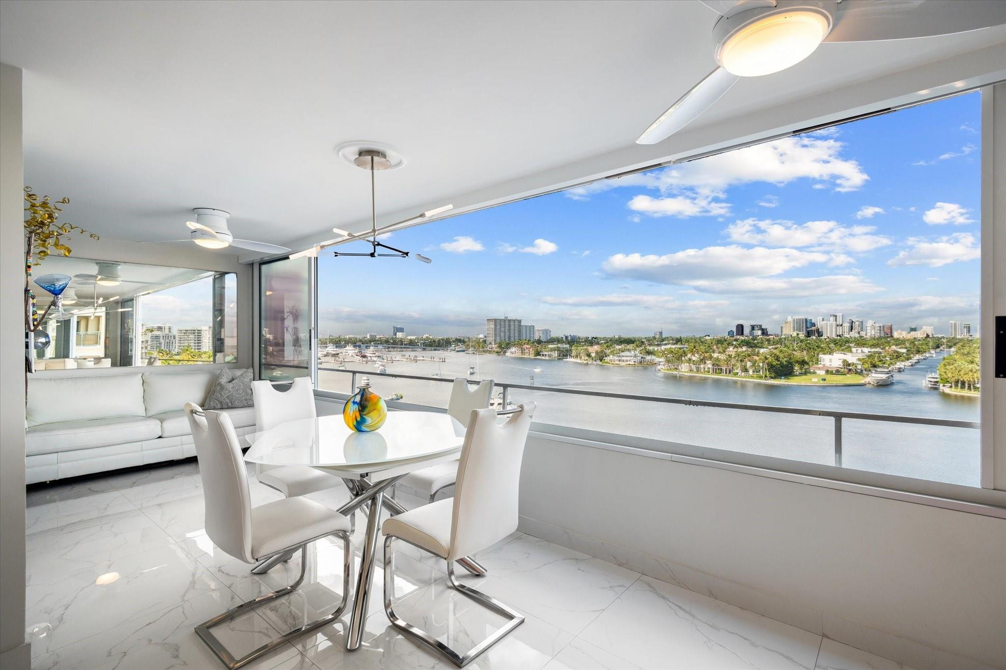 215 North Birch Road, Unit 8C Fort Lauderdale, FL 33304 - Photo 10 of 22 a view of a dining room with furniture one side kitchen view and wooden floor