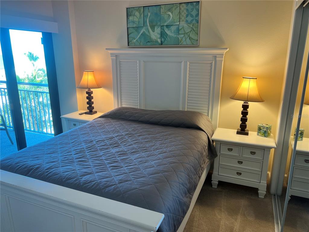 1001 Point Of Rocks Road, Unit 412 Sarasota, FL 34242 - Photo 13 of 43 a bed sitting in a bedroom next to a window