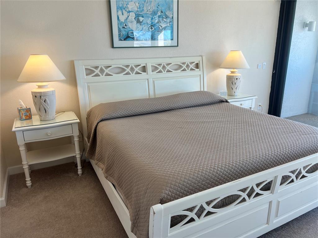 1001 Point Of Rocks Road, Unit 412 Sarasota, FL 34242 - Photo 17 of 43 a bedroom with a bed and a lamp