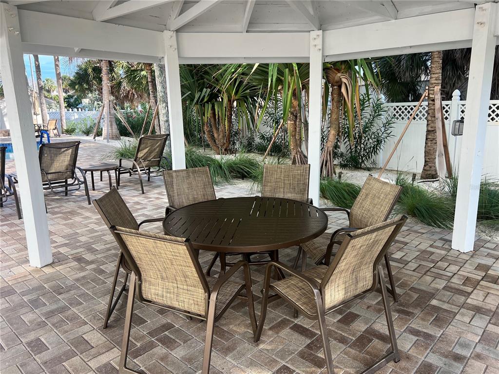 1001 Point Of Rocks Road, Unit 412 Sarasota, FL 34242 - Photo 29 of 43 a view of an outdoor dining space with a table and chairs
