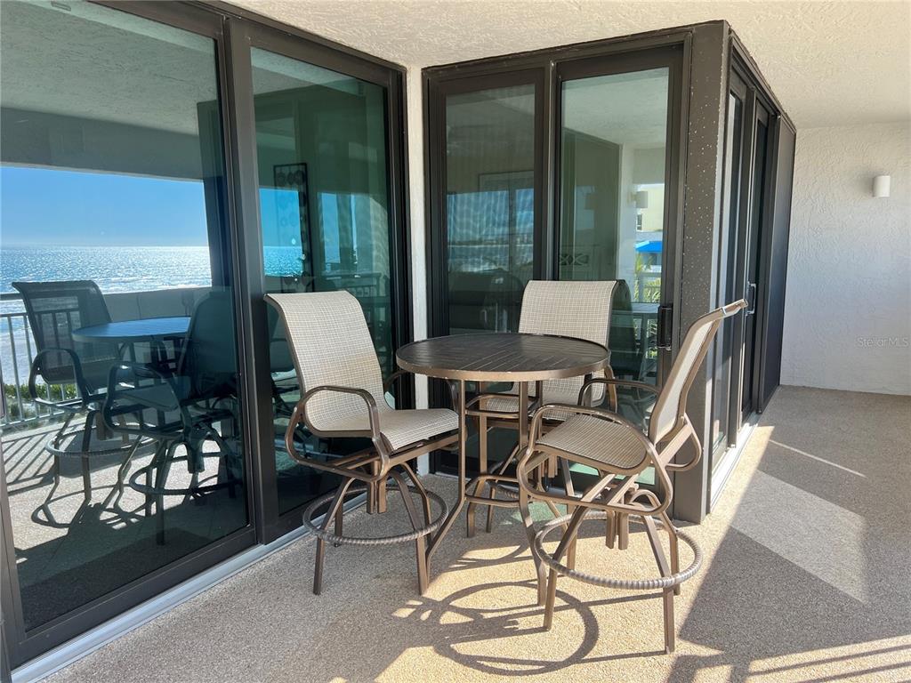 1001 Point Of Rocks Road, Unit 412 Sarasota, FL 34242 - Photo 4 of 43 a dining room with furniture and a floor to ceiling window