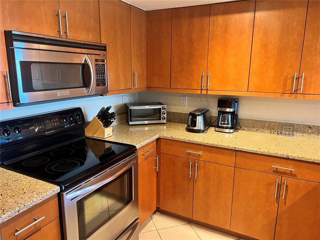 1001 Point Of Rocks Road, Unit 412 Sarasota, FL 34242 - Photo 6 of 43 a kitchen with a stove and a microwave