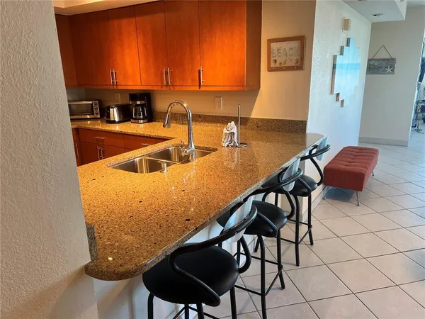 a view of a kitchen with kitchen island and a sink