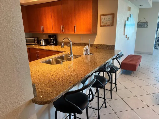 a view of a kitchen with kitchen island and a sink