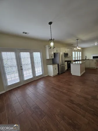 a view of an empty room and wooden floor