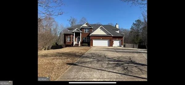 a view of a hallway view with wooden floor and a chandelier