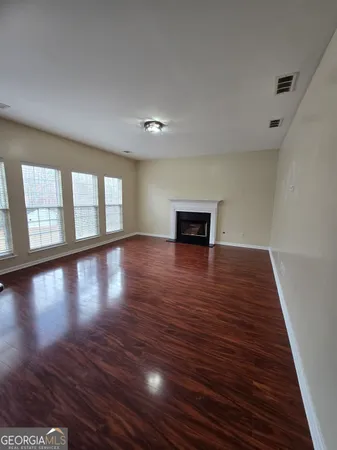a view of a room with wooden floor