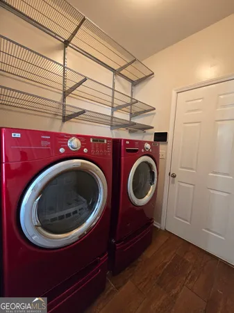 a view of a room with wooden floor and ceiling fan