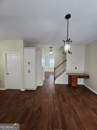 a view of a field with trees in the background