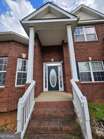a view of a hallway with wooden floor and chandelier
