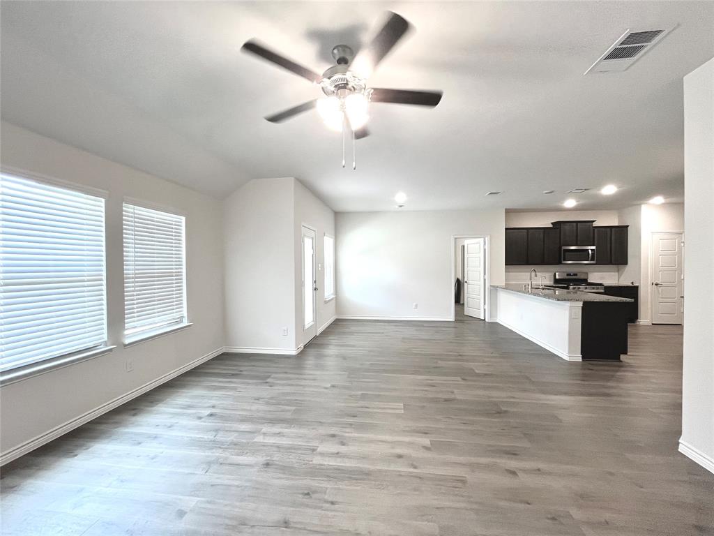 758 Musket Street Fate, TX 75189 - Photo 12 of 26 Unfurnished living room with ceiling fan, wood finished floors, and recessed lighting