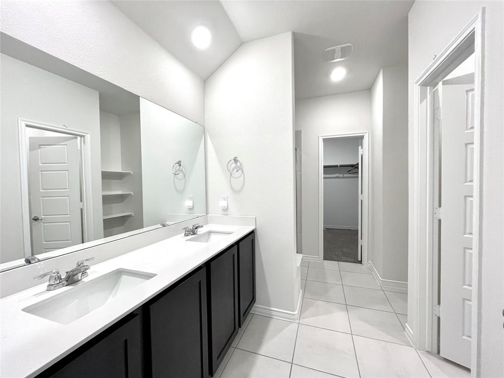 758 Musket Street Fate, TX 75189 - Photo 20 of 26 Full bath featuring double vanity, a walk in closet, tile patterned flooring, and recessed lighting