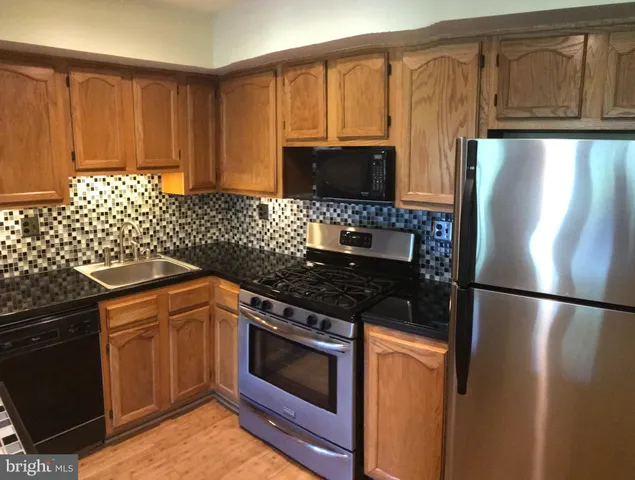 a kitchen with a refrigerator stove and microwave