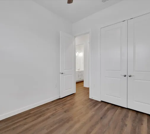 a view of a room with wooden floor