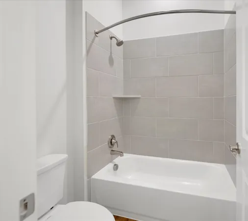 a bathroom with a shower and a toilet