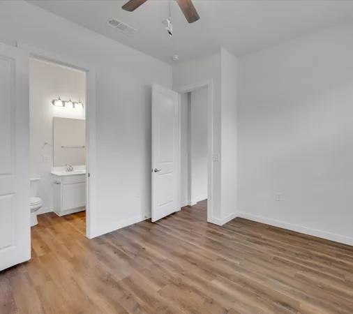 a view of a room with wooden floor and sink