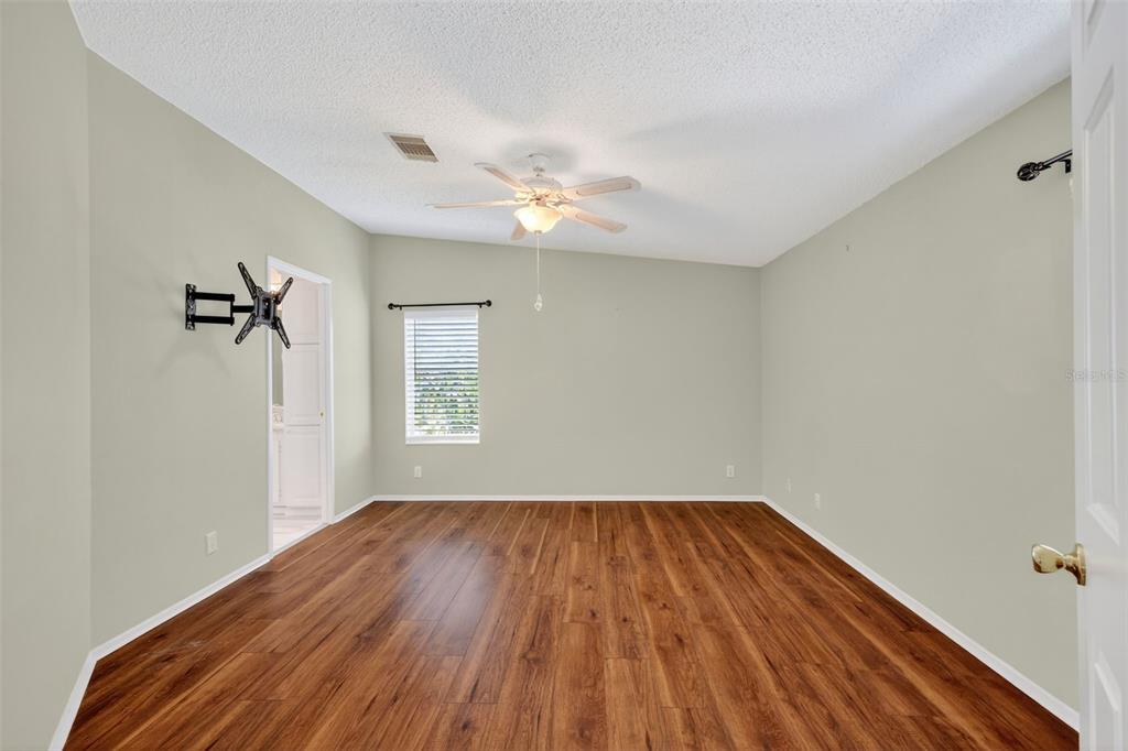 3024 Manatee Road Tavares, FL 32778 - Photo 16 of 39 a view of empty room with a window and wooden floor