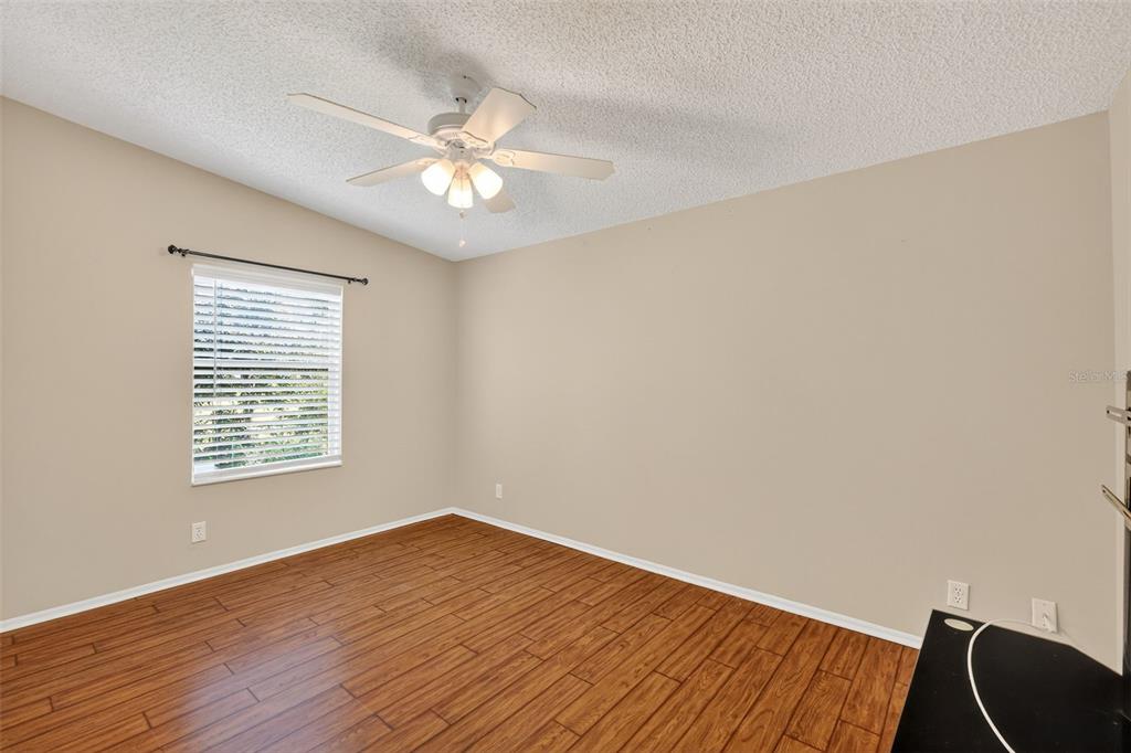 3024 Manatee Road Tavares, FL 32778 - Photo 21 of 39 a view of an empty room with wooden floor and a window