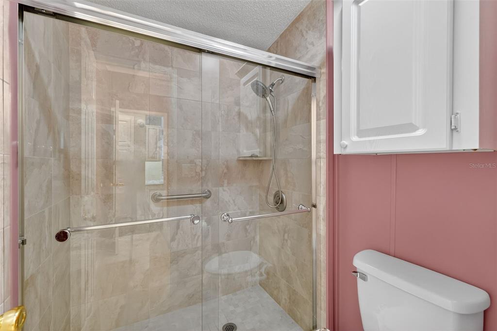 3024 Manatee Road Tavares, FL 32778 - Photo 22 of 39 a bathroom with a shower and toilet
