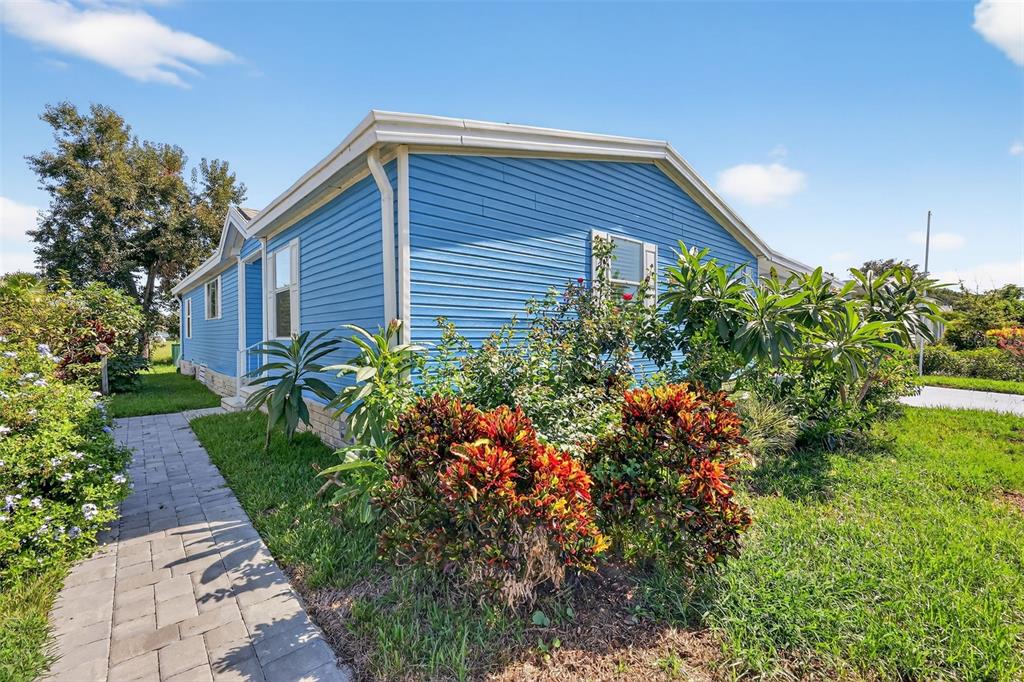 3024 Manatee Road Tavares, FL 32778 - Photo 31 of 39 a front view of house with garden and trees